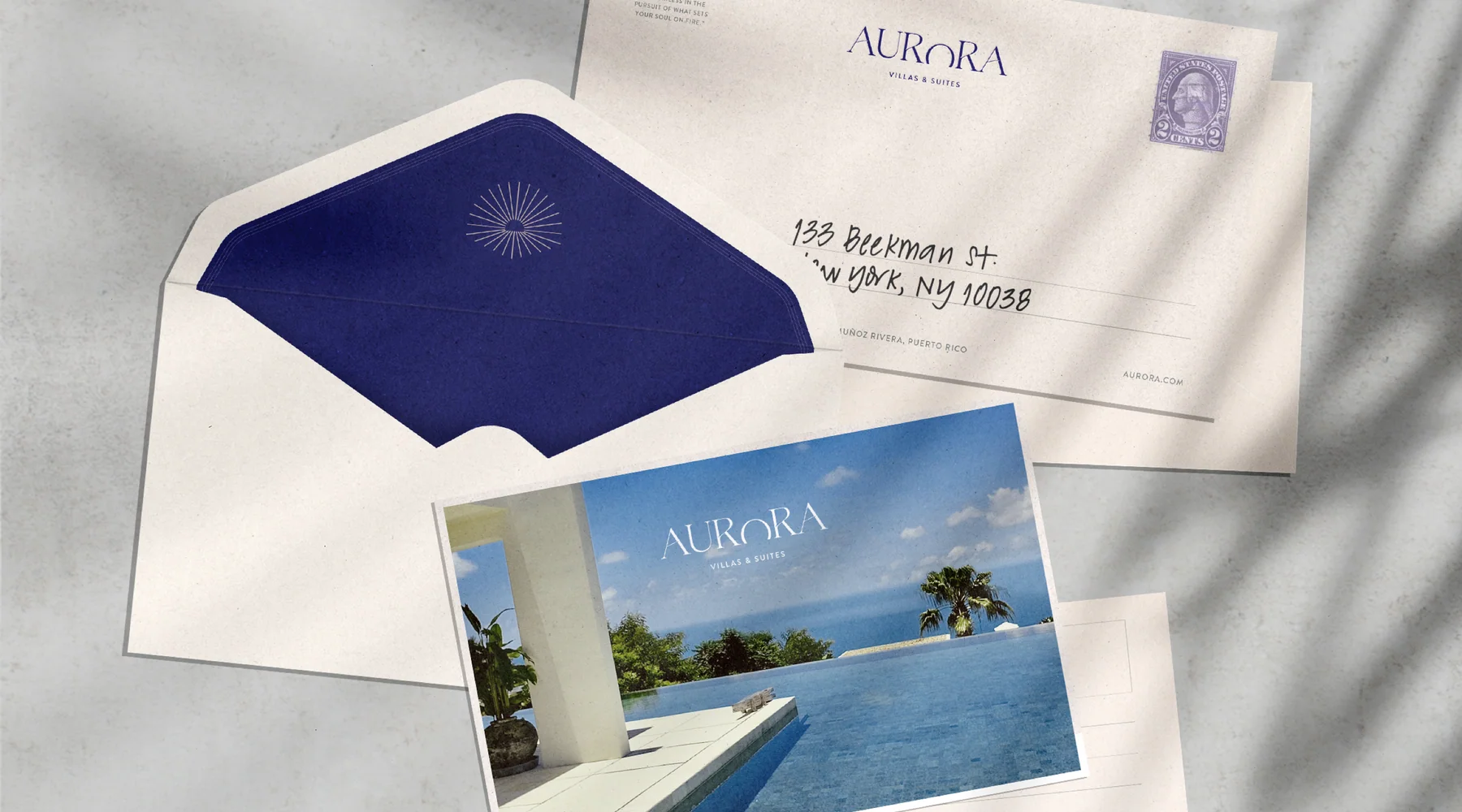 Aurora postcard and envelope mockup with the sun motif and a hospitality photograph